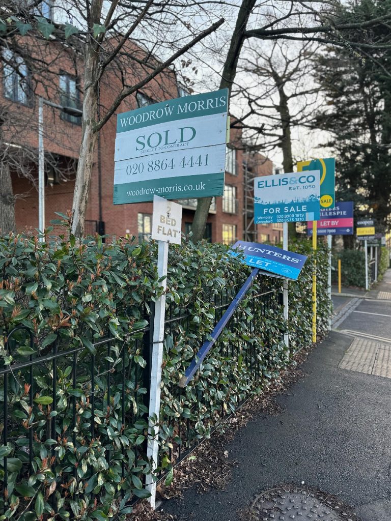 estate agent signs outside a building