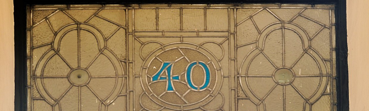 Stained glass window above the entry door at 40 Queensborough Terrace.