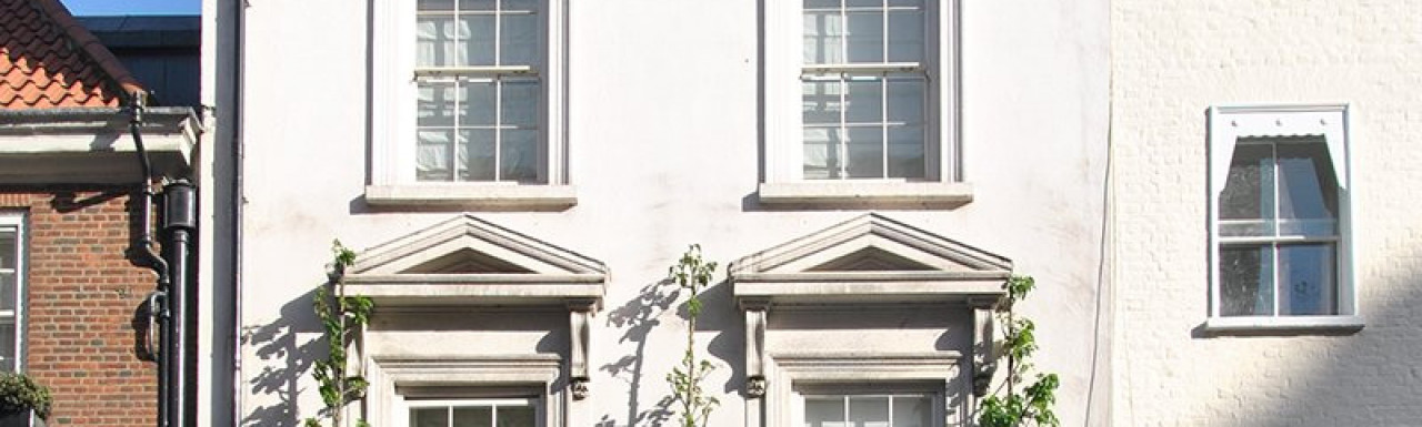 60 Park Street - Doric porch to right in front of flat arched doorway with fanlight above the panelled door.
