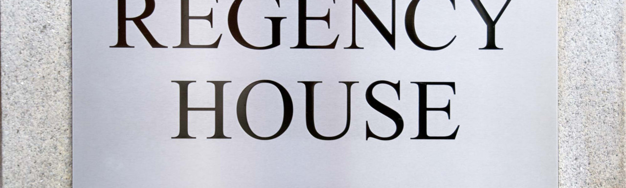 Regency House building sign next to the entrance.