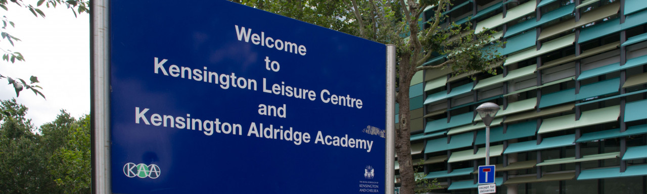 Welcome to Kensington Leisure Centre and Kensington Aldridge Academy - sign next to the building; view from Silchester Road.