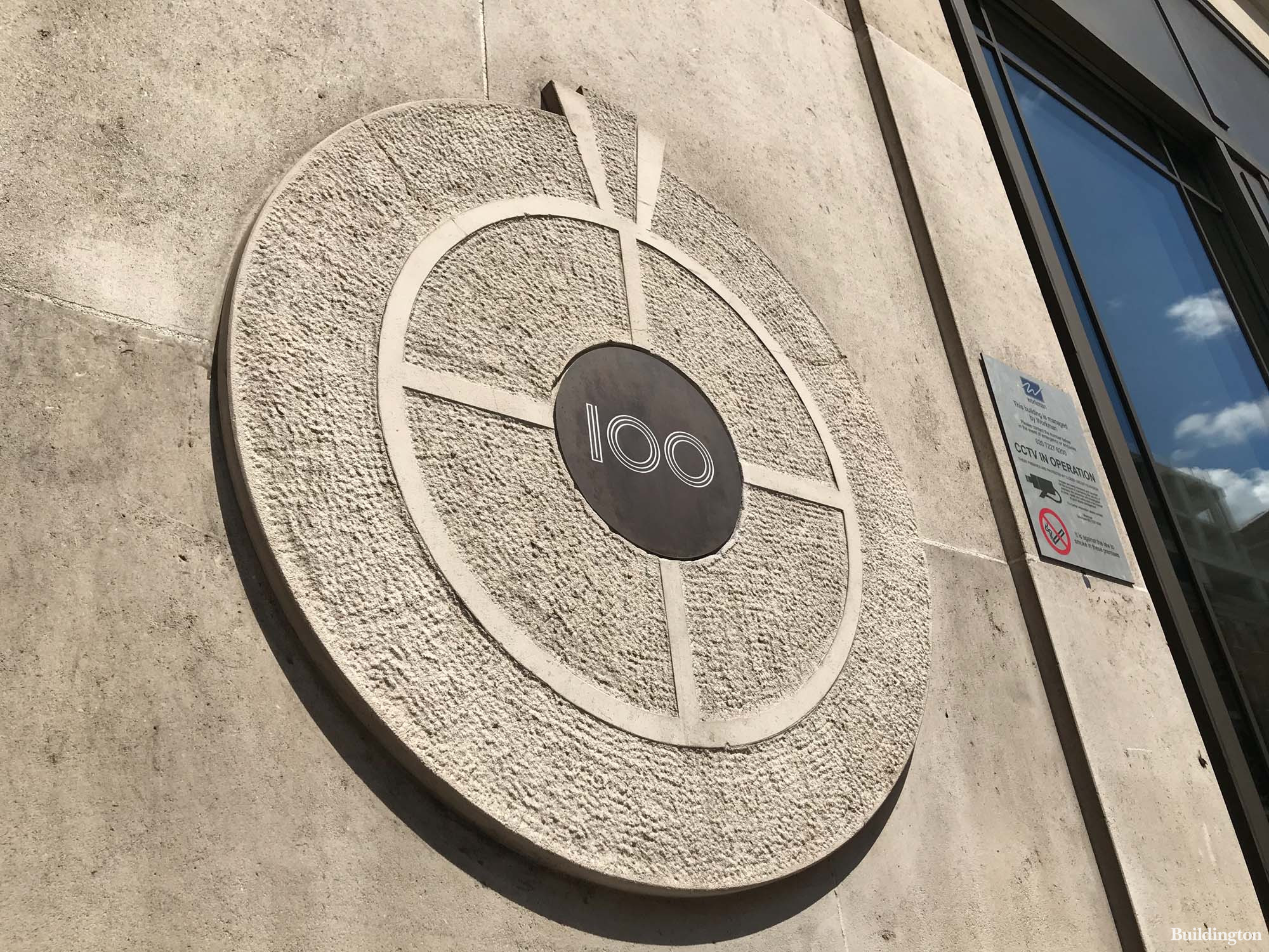 100 Oxford Street sign on the building at the entrance.