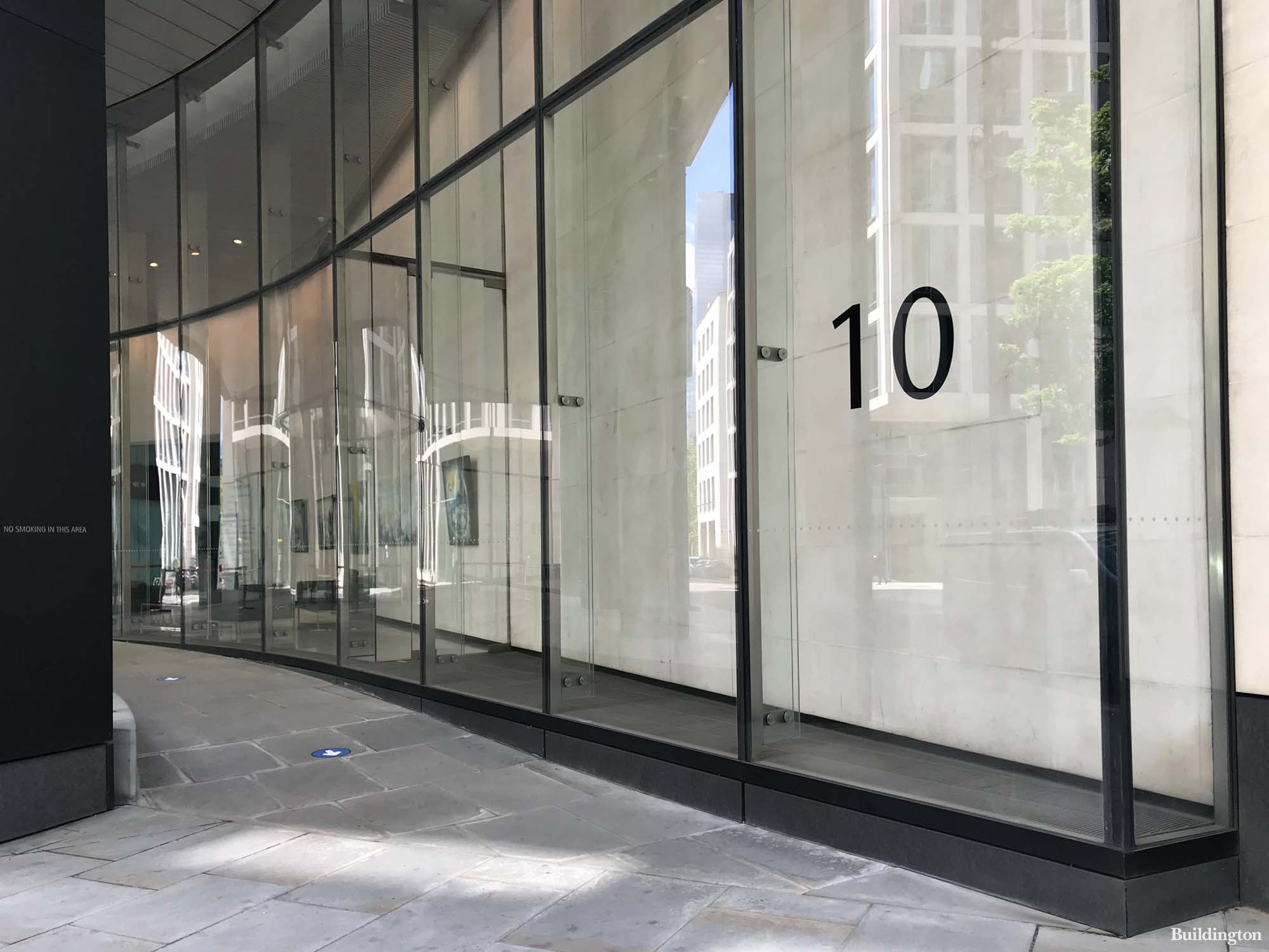 In front of 10 Gresham Street office building in the City of London designed by Foster + Partners.