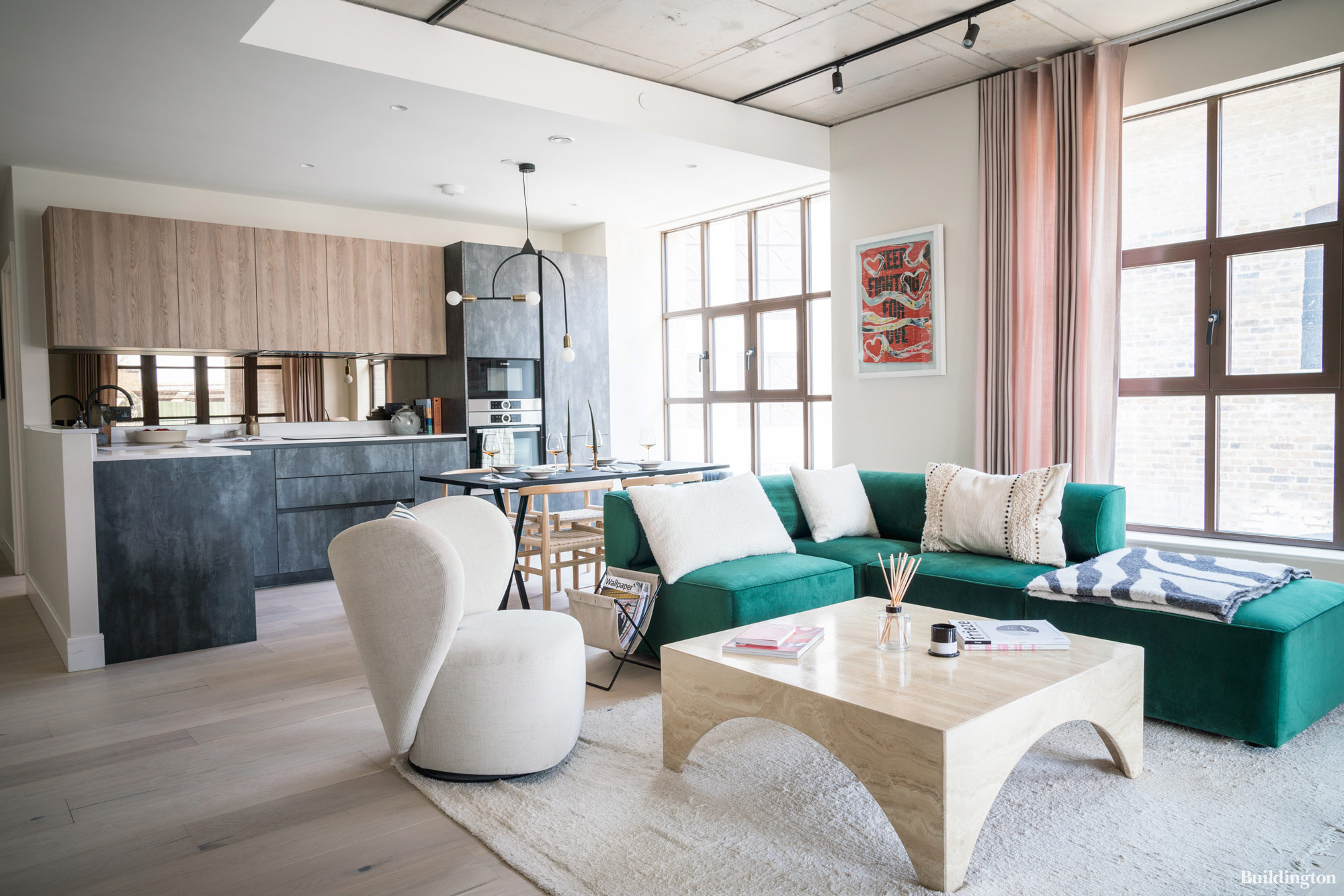 The apartments at Empress Works development by Aitch Group feature wide plank pale timber flooring, matt bronze finishes and large warehouse style windows flooding rooms with light.