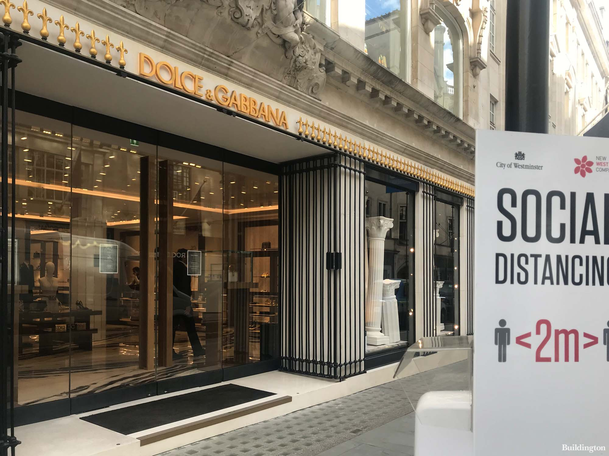 Social distancing banner in front of Dolce & Gabbana store at 6-8 Old Bond Street in Mayfair, London W1.